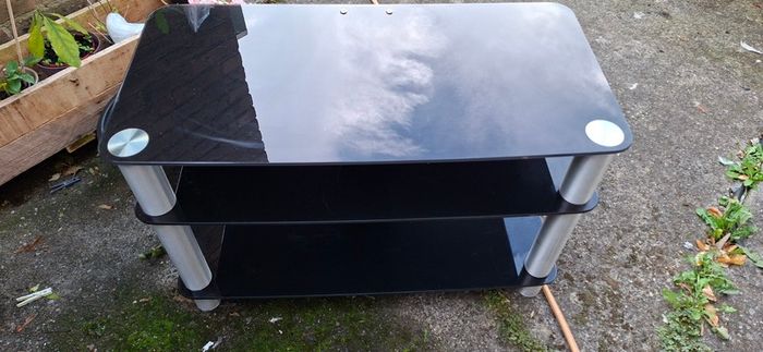 Black glass TV stand with silver legs