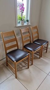 Marks & Spencer solid oak ladder-back dining chairs with 100% brown leather seat pads.