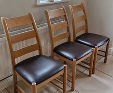 Marks & Spencer solid oak ladder-back dining chairs with 100% brown leather seat pads.
