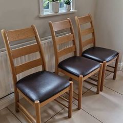 Marks & Spencer solid oak ladder-back dining chairs with 100% brown leather seat pads.