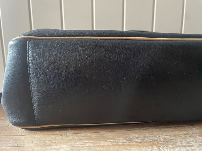 Tula black leather tote bag with a shoulder strap.