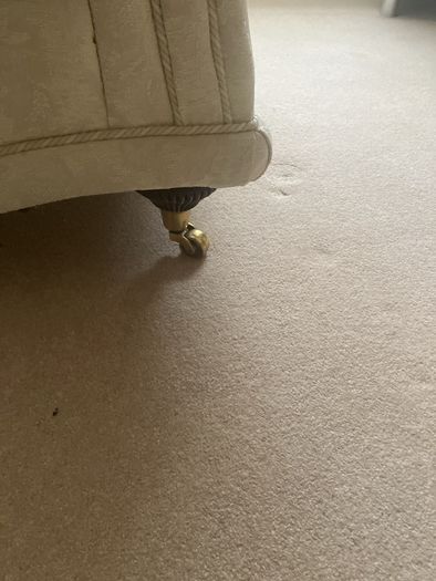 Cream armchair on brass caster