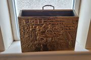 Vintage brass magazine rack with embossed tavern scene