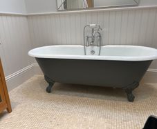Roll top cast iron bath with taps