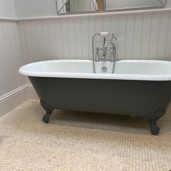 Roll top cast iron bath with taps