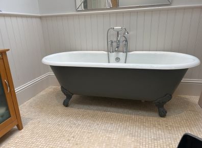 Roll top cast iron bath with taps
