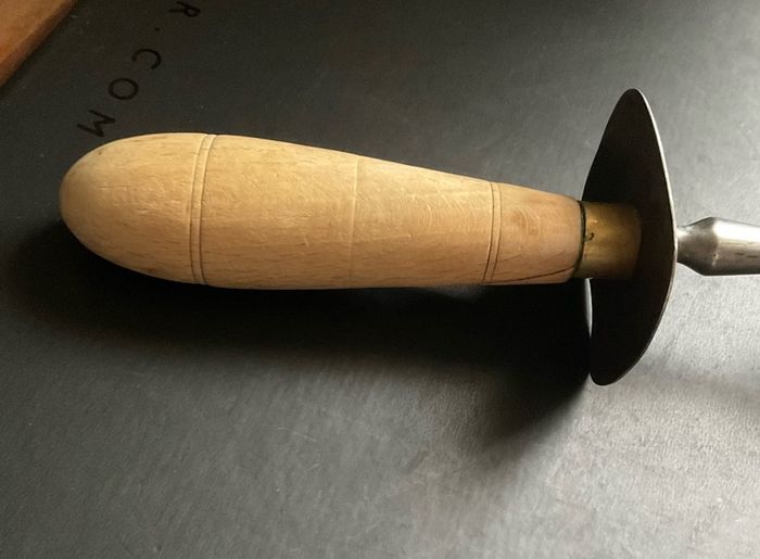 vintage meat carving fork is made of solid steel with a wooden handle and guard possible 1966 British army