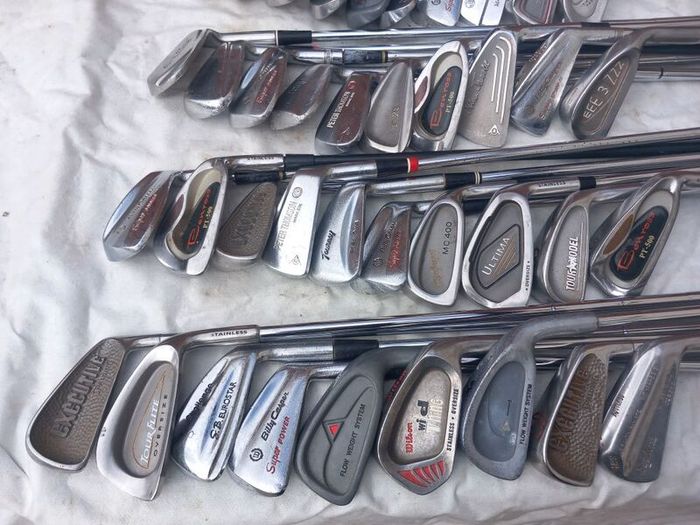 A selection of golf clubs and bags. Golf balls