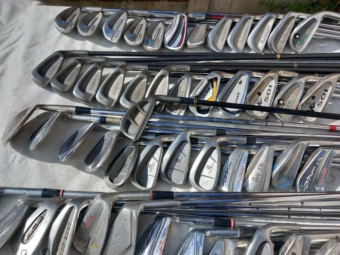 A selection of Golf clubs. Bags and golf balls.