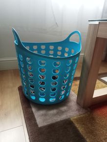 Blue plastic laundry basket