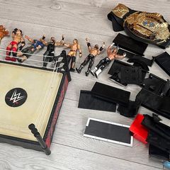 WWE wrestling ring with figures and championship belt