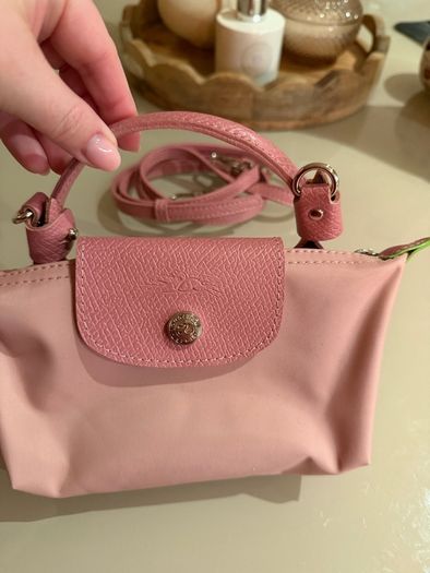 pink Longchamp Le Pliage mini top-handle bag with a detachable shoulder strap