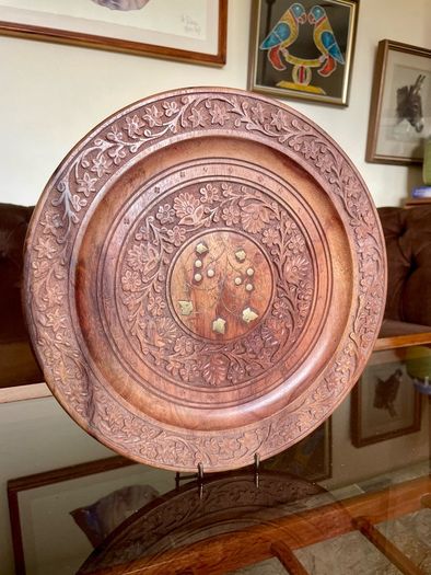 Beautiful vintage hand-carved wooden tray featuring an intricate floral border and a decorative brass inlay geometric star motif in the centre. The craftsmanship is detailed and very tactile, giving this piece a rich, warm character. The tray is solid and