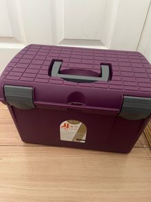 Equestrian grooming box and brushes.