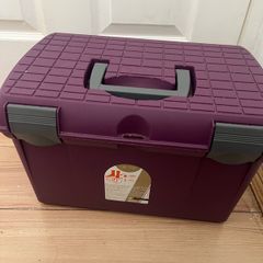 Equestrian grooming box and brushes.