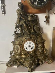 Antique French renaissance brass mantel clock with knight figure  pair of renaissance brass candlesticks with enamel inlays.