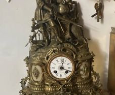 Antique French renaissance brass mantel clock with knight figure  pair of renaissance brass candlesticks with enamel inlays.