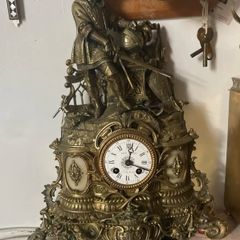 Antique French renaissance brass mantel clock with knight figure  pair of renaissance brass candlesticks with enamel inlays.