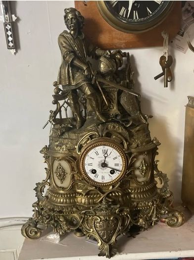 Antique French renaissance brass mantel clock with knight figure  pair of renaissance brass candlesticks with enamel inlays.