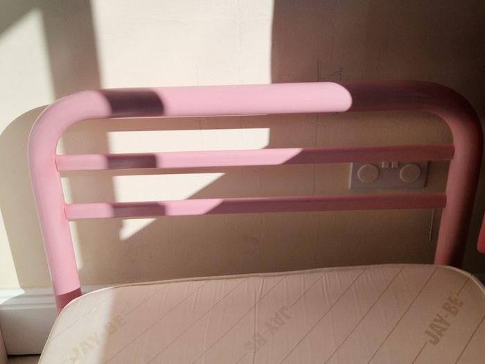 Pink metal frame toddler bed
