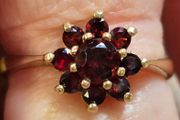 Gold ring floral design with garnet