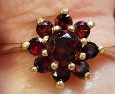 Gold ring floral design with garnet