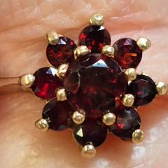 Gold ring floral design with garnet