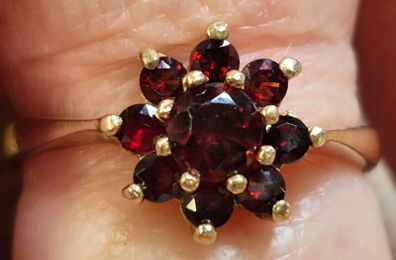 Gold ring floral design with garnet