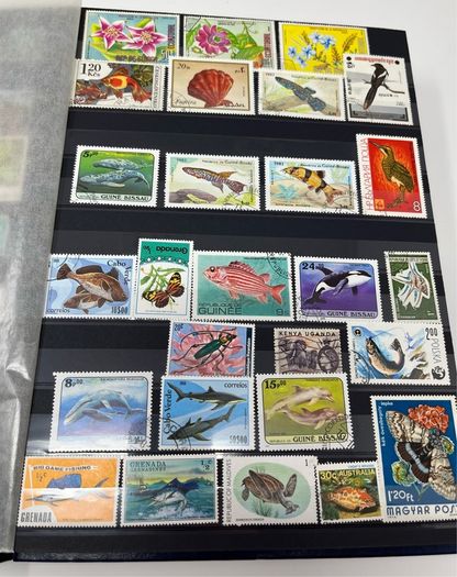 Ace Black 32 page/ 16 leaf Stamp Album with over 900 stamps. Thematic of Animals, Plants, Classic Cars, Space, Trains, Sport & Disney noted.