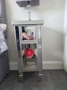 Two narrow mirrored bedside tables
