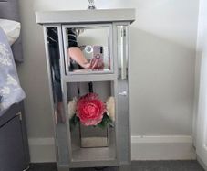 Two narrow mirrored bedside tables