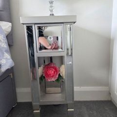Two narrow mirrored bedside tables