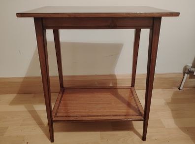Small hardwood table with decorative inlaid border on both shelves.