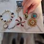 little  collection of broches,a chain and a charm  bracelet Image 2