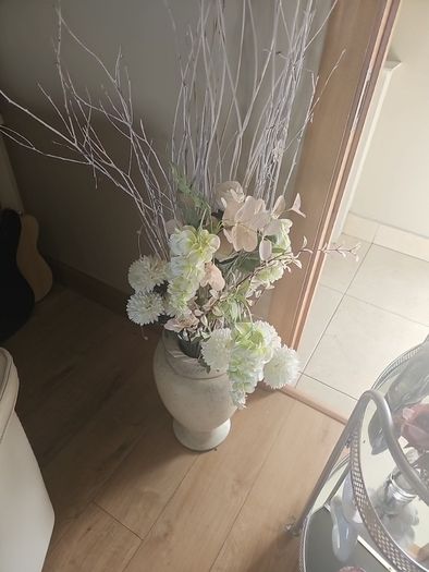 drinks trolly and large flower arrangement with vase