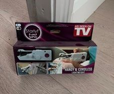 Hand-held sewing machine