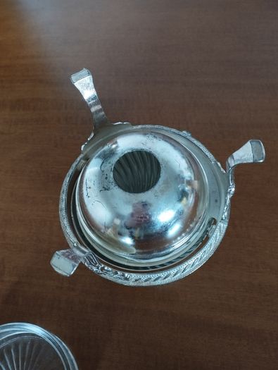 A vintage silver-plated butter dish or caviar bowl with a three-legged lid.
