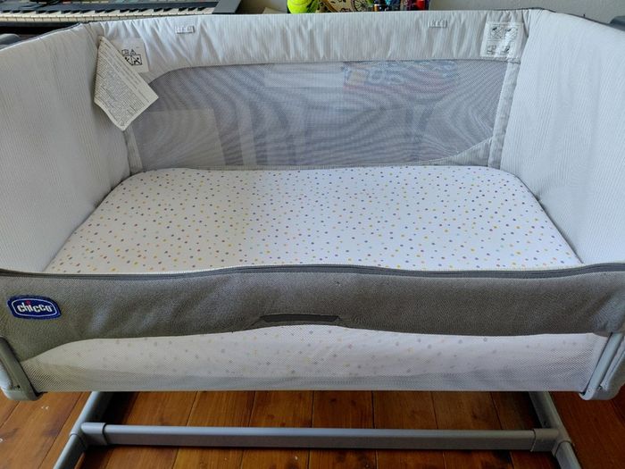 Next to me Chicco magic cot with snuz breatheble matress and bed sheets.