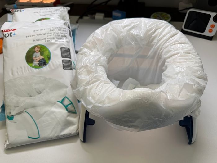 Oxo travel potty potty training foldable with 100 disposable bags