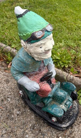 Vintage Reconstuted stone garden gnome on car, hand painted