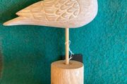 Hand crafted bird on timber perch. New