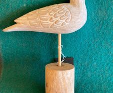 Hand crafted bird on timber perch. New