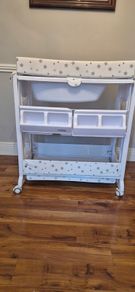Baby changing unit with bath and draining tube
