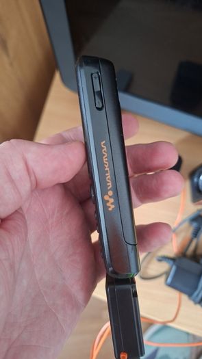 Sony Ericsson W200i , with charger and speakers.