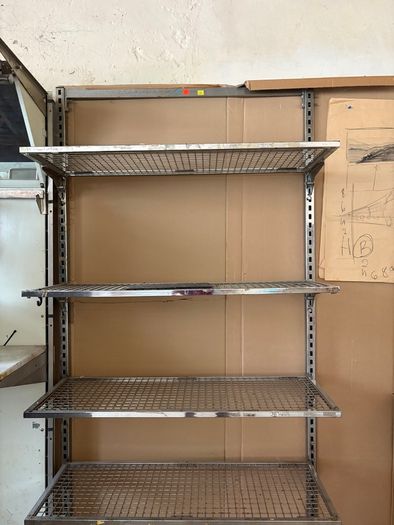 commercial-grade, wall-mounted twin-slot wire shelving system featuring adjustable chrome or galvanized steel mesh shelves.