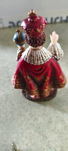 Infant of Prague devotional figurine featuring ornate red and gold robes and a matching crown.