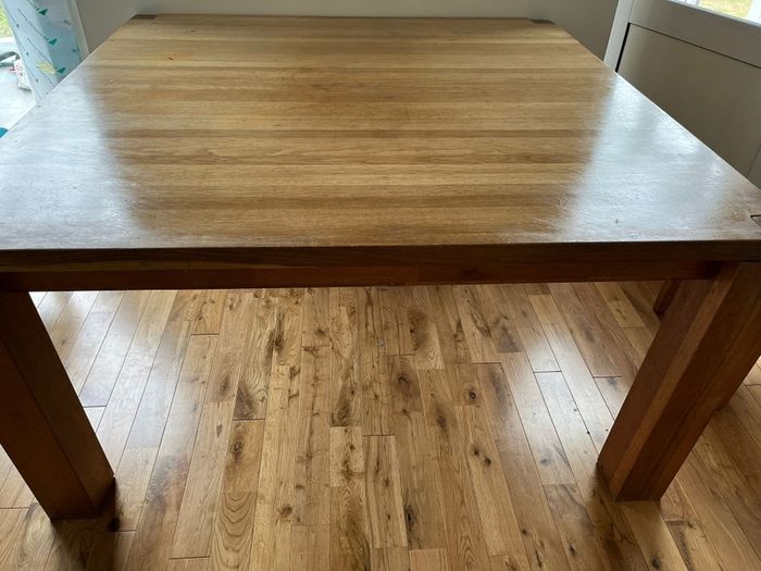 oak , solid table very heavy.  Square . Fits 6