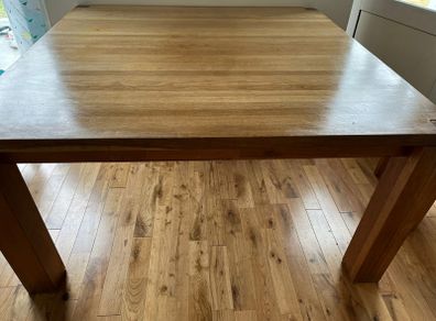 oak , solid table very heavy.  Square . Fits 6