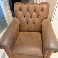 Pair of brown leather chesterfield armchairs