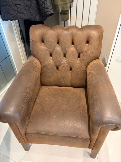 Pair of brown leather chesterfield armchairs